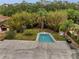 Aerial view of backyard pool surrounded by lush greenery and foliage provides ultimate privacy at 2303 Bonneville Dr, Orlando, FL 32826
