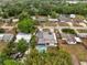 Aerial view of a single Gathering home with a pool and lush surrounding greenery in a residential neighborhood at 2303 Bonneville Dr, Orlando, FL 32826