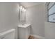 Updated bathroom featuring a gray vanity, white fixtures, and light wood-look floors at 2303 Bonneville Dr, Orlando, FL 32826