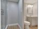Updated bathroom featuring a shower with glass doors, updated vanity, and toilet at 2303 Bonneville Dr, Orlando, FL 32826