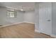 Bedroom with ceiling fan, neutral walls and wood-look floors with window and door at 2303 Bonneville Dr, Orlando, FL 32826