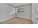 Bedroom with light gray walls, light wood-look floors, and a window at 2303 Bonneville Dr, Orlando, FL 32826