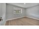 A bright bedroom featuring wood-look flooring and a window overlooking the backyard at 2303 Bonneville Dr, Orlando, FL 32826