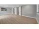 A spacious bedroom with wood-look floors, gray walls and closet with sliding doors at 2303 Bonneville Dr, Orlando, FL 32826