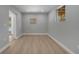 Neutral empty room featuring light gray walls, two windows, and new wood flooring at 2303 Bonneville Dr, Orlando, FL 32826