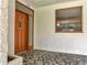 Home's front entrance featuring a wood door and a tile front porch at 2303 Bonneville Dr, Orlando, FL 32826