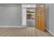 Open doorway leading to the backyard, featuring a patterned patio and a wood-finished front door at 2303 Bonneville Dr, Orlando, FL 32826