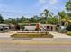 Mid-century home featuring a concrete fence, stucco walls, and orange trim at 2303 Bonneville Dr, Orlando, FL 32826