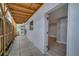 Exterior view of a covered walkway with a wooden fence, light walls and an open doorway at 2303 Bonneville Dr, Orlando, FL 32826
