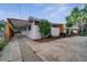 Exterior view of the home highlighting the textured facade and multiple carport spaces at 2303 Bonneville Dr, Orlando, FL 32826