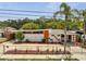 Unique mid-century home featuring a concrete fence, stucco walls, and orange trim at 2303 Bonneville Dr, Orlando, FL 32826