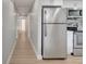 Hallway leading to stainless steel refrigerator and modern kitchen at 2303 Bonneville Dr, Orlando, FL 32826