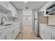 Modern kitchen featuring white cabinets, stainless steel appliances, and streamlined design at 2303 Bonneville Dr, Orlando, FL 32826