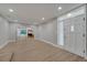 Open concept living room with sleek floors, a glass sliding door, and an inviting white entry door at 2303 Bonneville Dr, Orlando, FL 32826