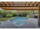 Backyard pool surrounded by lush greenery and a covered patio offers a private oasis at 2303 Bonneville Dr, Orlando, FL 32826