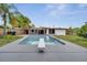 Backyard pool with diving board and surrounding lush greenery makes a great place to relax at 2303 Bonneville Dr, Orlando, FL 32826