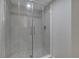 Modern glass shower with marble look tile and contemporary shower head at 2303 Bonneville Dr, Orlando, FL 32826