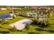 Aerial view showcasing the community's volleyball court, pool, and lush landscaping by a lake at 2382 Zaballina Pl, Kissimmee, FL 34747