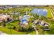 Aerial view of the community amenities, including a pool, water park, lake, and playground at 2382 Zaballina Pl, Kissimmee, FL 34747