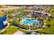 Aerial view showcases the community's pool, water park, clubhouse, and lush landscaping at 2382 Zaballina Pl, Kissimmee, FL 34747
