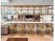 Modern bar area with marble countertop, metal accents, comfortable seating, and a stylish display shelf at 2382 Zaballina Pl, Kissimmee, FL 34747