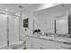 Bright bathroom featuring a walk-in shower, granite countertop, modern fixtures, and large mirror at 2382 Zaballina Pl, Kissimmee, FL 34747
