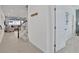 Bright hallway featuring tile flooring, staircase, and an open doorway to the living area with ample natural light at 2382 Zaballina Pl, Kissimmee, FL 34747