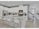 Bright kitchen featuring stainless steel appliances, white cabinetry, granite countertops, and island seating at 2382 Zaballina Pl, Kissimmee, FL 34747