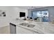 Stylish kitchen featuring granite countertops, stainless steel appliances, and seamlessly integrates with the living room at 2382 Zaballina Pl, Kissimmee, FL 34747