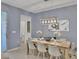 Open-concept living space showing the dining table, entrance to a bathroom, and artwork on the wall at 2382 Zaballina Pl, Kissimmee, FL 34747