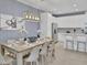Bright living space with dining area, island seating, and stainless steel appliances in the modern kitchen at 2382 Zaballina Pl, Kissimmee, FL 34747