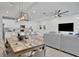 Open-concept living space featuring dining table, kitchen with island, and comfortable seating area at 2382 Zaballina Pl, Kissimmee, FL 34747