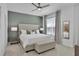 Cozy main bedroom featuring tufted headboard, ceiling fan, and natural light from the nearby window at 2382 Zaballina Pl, Kissimmee, FL 34747