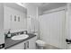 Full bathroom featuring a shower with curtain, single sink vanity, and updated lighting at 242 Milestone Dr, Haines City, FL 33844