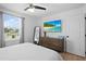 Relaxing bedroom offers natural light, a comfortable bed, a modern TV, and soft textures for a serene space at 242 Milestone Dr, Haines City, FL 33844