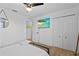 Stylish bedroom features a comfortable bed, large closet, mounted TV, and light hardwood floors at 242 Milestone Dr, Haines City, FL 33844
