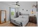 Cozy bedroom offers natural light, a comfortable bed, and rustic decor for a relaxing retreat at 242 Milestone Dr, Haines City, FL 33844