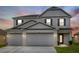Charming two-story home with a three-car garage and manicured lawn, perfect for families at 242 Milestone Dr, Haines City, FL 33844