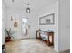 Bright foyer featuring neutral tile flooring, console table, mirror, and decorative plants at 242 Milestone Dr, Haines City, FL 33844