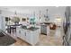 Open-concept kitchen with a granite island, stainless steel appliances, and view into the living space at 242 Milestone Dr, Haines City, FL 33844