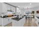 Stylish kitchen featuring white cabinetry, an island with seating, and stainless steel appliances at 242 Milestone Dr, Haines City, FL 33844