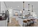 Open-concept kitchen featuring granite countertops, stainless steel appliances, and a breakfast bar at 242 Milestone Dr, Haines City, FL 33844