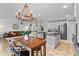 Open concept kitchen and living area boasts modern lighting, stainless appliances, and a spacious layout for entertaining at 242 Milestone Dr, Haines City, FL 33844