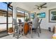 Relaxing screened lanai with a bar, outdoor seating and a ceiling fan at 242 Milestone Dr, Haines City, FL 33844