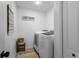 The laundry room features modern washer and dryer, a charming Lost Sock sign, and basket at 242 Milestone Dr, Haines City, FL 33844