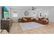 Bright living room features two sofas, large rug, windows, and a TV at 242 Milestone Dr, Haines City, FL 33844
