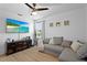 Comfortable living room with luxury vinyl plank flooring, a ceiling fan, and a flatscreen tv at 242 Milestone Dr, Haines City, FL 33844