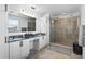 Elegant main bathroom featuring granite countertops, double sinks, and glass shower enclosure at 242 Milestone Dr, Haines City, FL 33844
