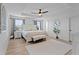 Bright main bedroom featuring tray ceilings, luxury vinyl plank flooring, and lots of natural light at 242 Milestone Dr, Haines City, FL 33844
