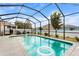 Inviting screened pool with lounge chairs, landscaping, and clear blue water for relaxation at 242 Milestone Dr, Haines City, FL 33844
